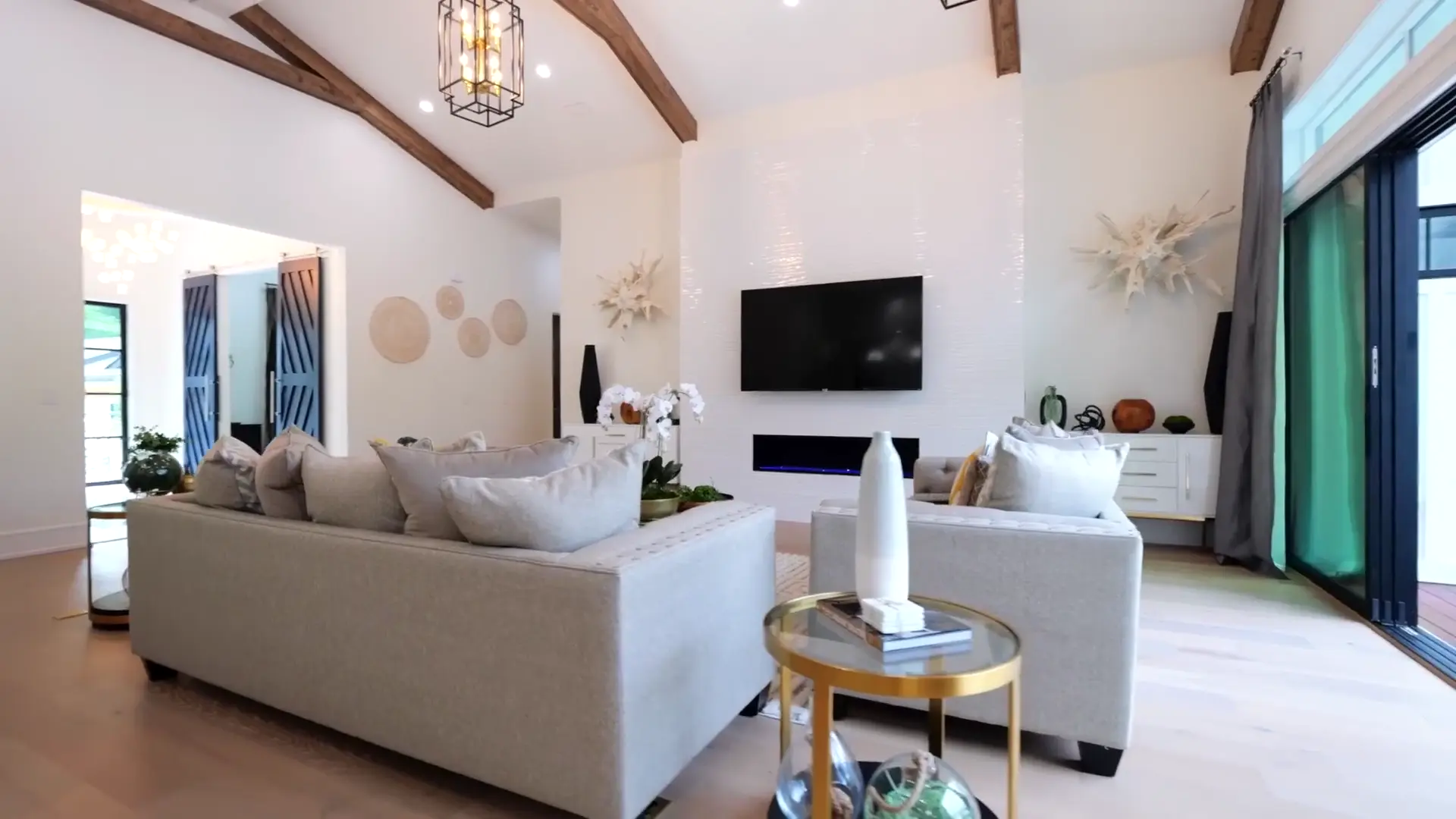 Light from the full-height glazing reaching across the sitting room